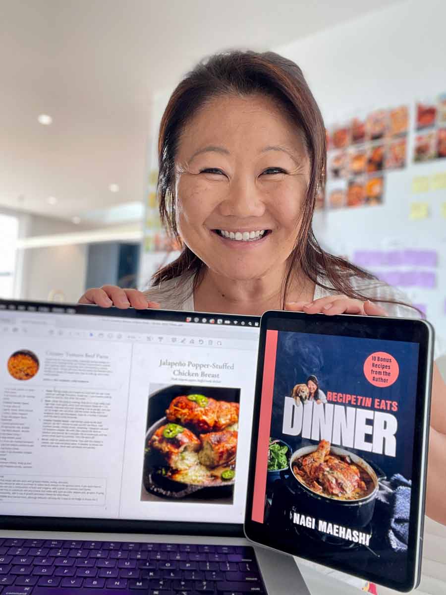 Nagi Maehashi holding the free bonus recipe book for "Dinner" cookbook early buyers