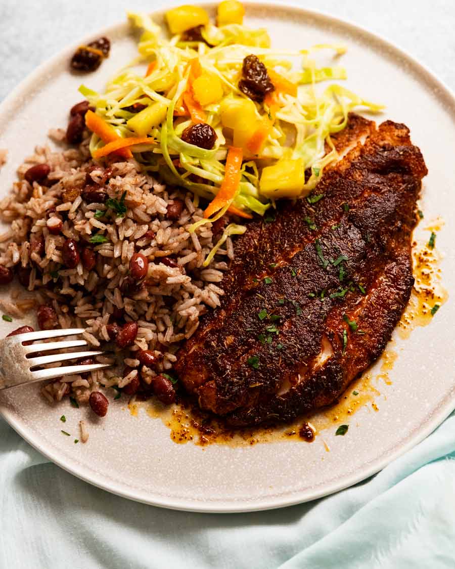Jamaican Jerk Fish on a plate with Jamaican Slaw and Coconut Rice & Beans