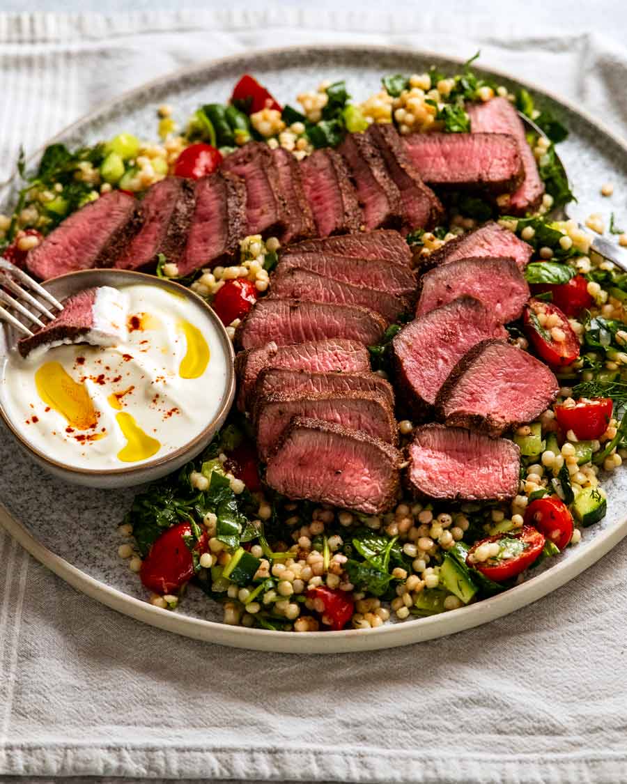 Platter of Moroccan lamb backstrap with pearl couscous salad