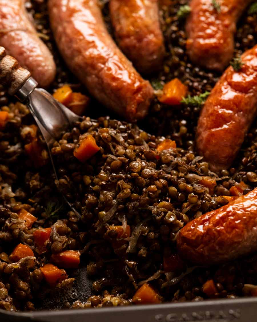 Close up   of One cookware  baked sausage and lentils