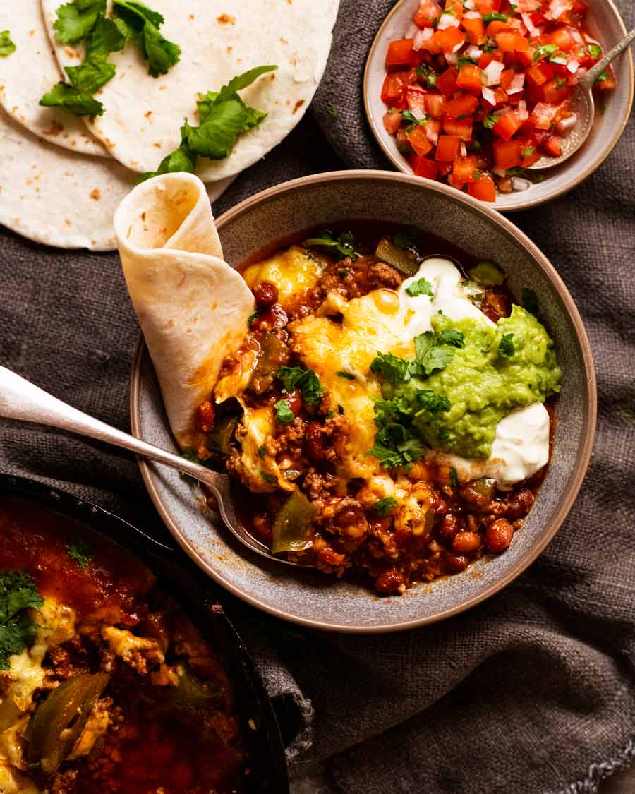 Overhead photo of Cheesy Mexican beef and bean casserole with tortillas