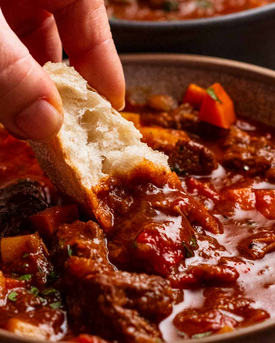 Dunking bread into Hungarian Goulash