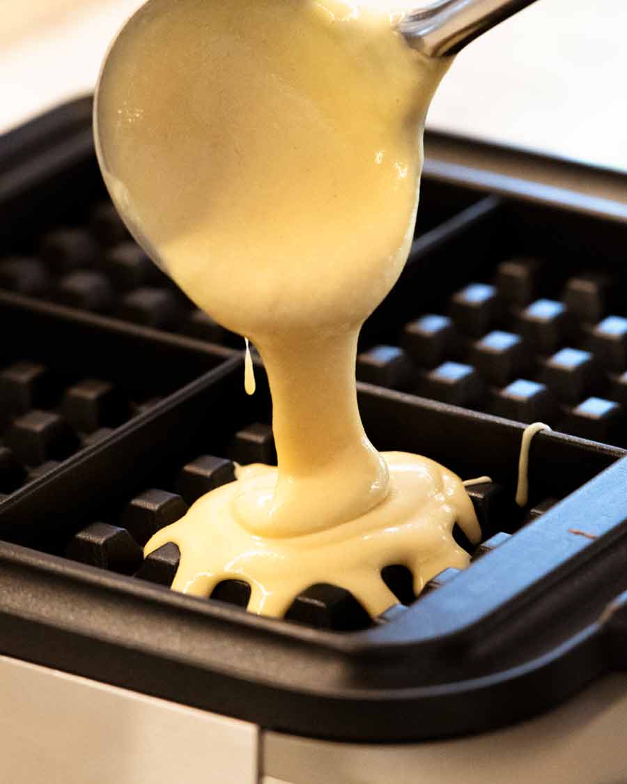 Pouring Waffle batter into waffle maker