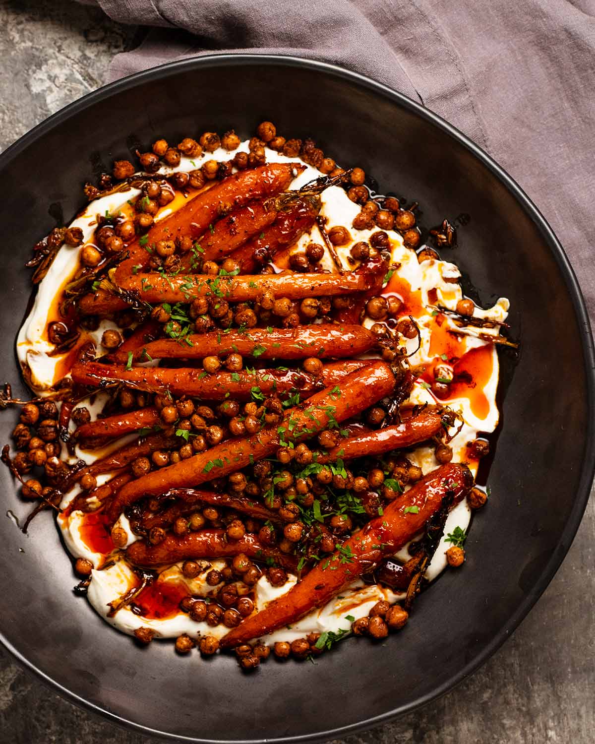 Spicy maple roasted carrots with crispy chickpeas with yogurt sauce ready to serve