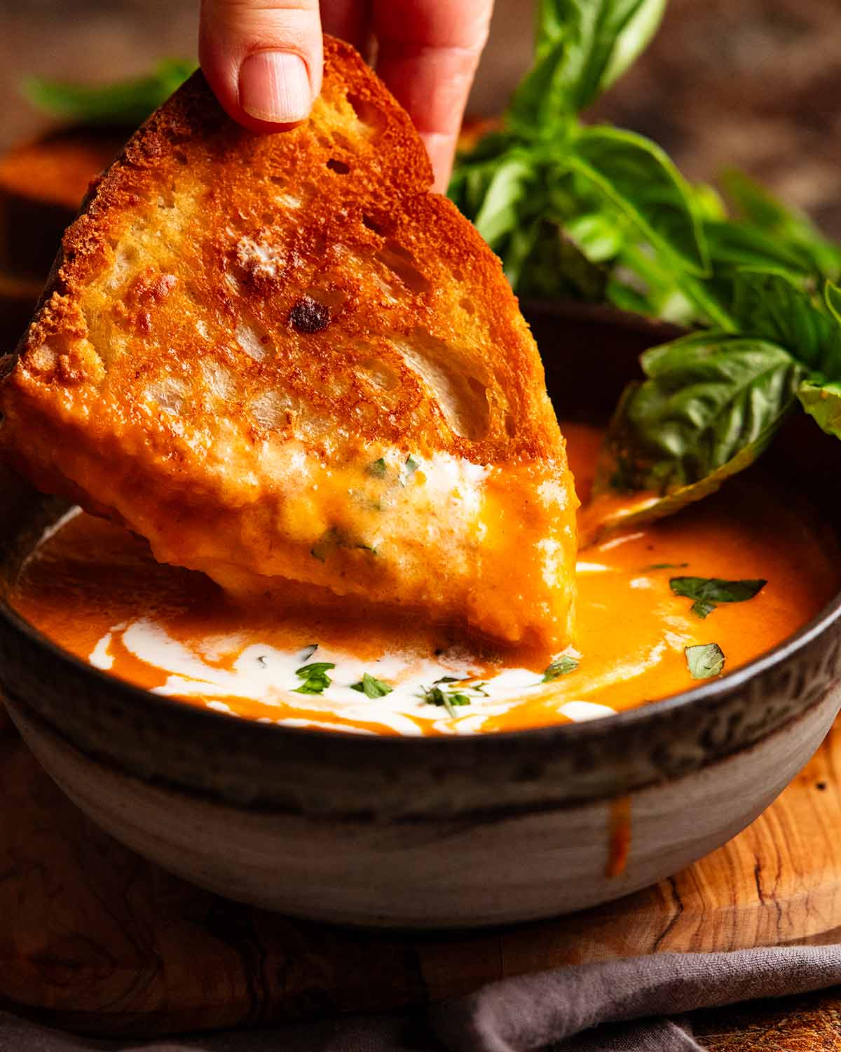 Dunnking grilled cheese into roasted tomato soup